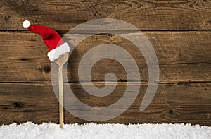 Wooden spoon with santa hat: rustic christmas background