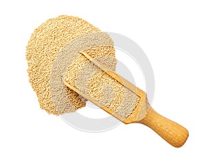 Wooden spoon or scoop with raw amaranth seen isolated on white background top view