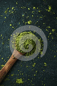 wooden spoon with some matcha powder tea