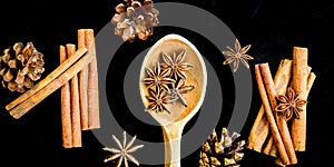 Wooden spoon with star anise, cinnamon sticks, cones, christmas spices background