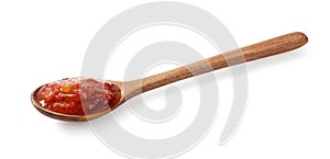 Wooden spoon and tomato sauce on white background