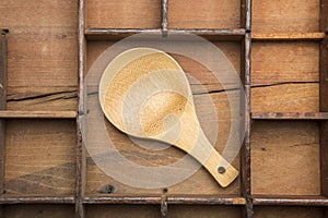 Wooden spoon on typeset tray.