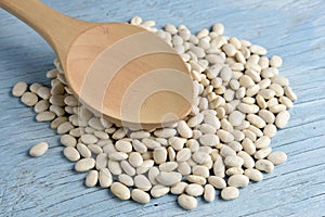 Wooden spoon with white beans