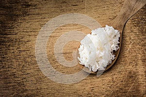 Wooden spoon white boiled rice on wood background