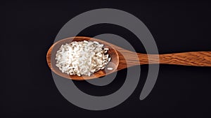 Wooden Spoon with White Rice, Close-up, Isolated Object, Black Background. Created with AI