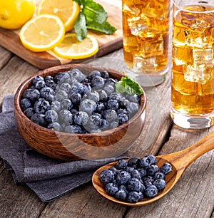 Wooden Spoonful and Bowl of Fresh Blueberries