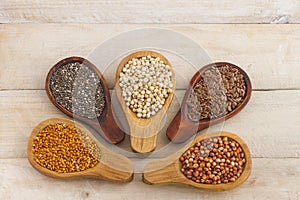 Wooden spoons with assorted grains of super foods, gluten free