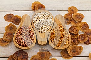 Wooden spoons with assorted grains of super foods, gluten free