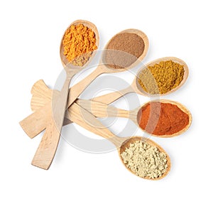 Wooden spoons with different spices on white background, top view