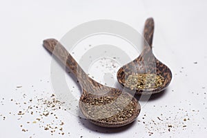 Wooden spoons with spices on white background.