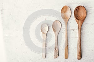 Wooden spoons on the white table top view