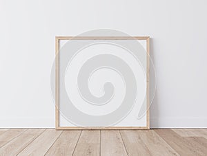 Wooden square frame Standing on parquet floor with white background, minimal frame mock up interior