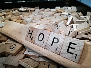Wooden square tiles letters spelling out the word `Hope`