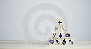 Wooden stacking with healthcare medical and hospital icons on table , Health and insurance concept