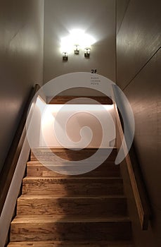 Wooden stair and three of lightings on the wall