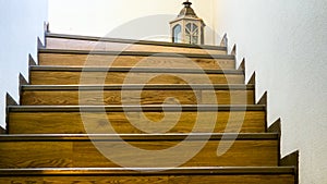 Wooden staircase with chandelier from a frog\'s eye perspective