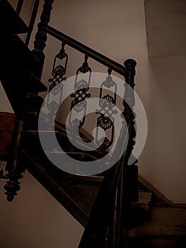 Wooden staircase handrailing in old historic building with no people. Interior decor of vintage stairs with ornaments
