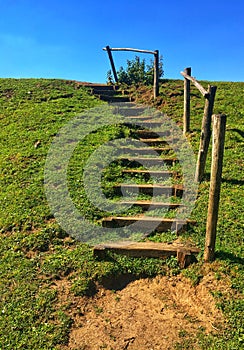 Wooden staircase on a hill to help people climb it easily