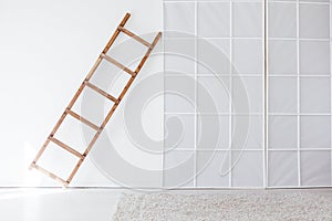 Wooden staircase in the interior of an empty white room