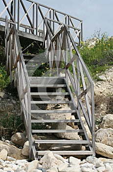 Wooden staircase on a stone beach