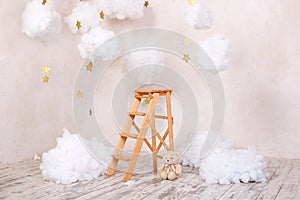 Wooden staircase stool with clouds in the children room. Children location for a photo shoot. Scandinavian style. Rustic room inte
