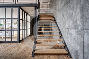 Wooden stairs in apartment house with modern interior design