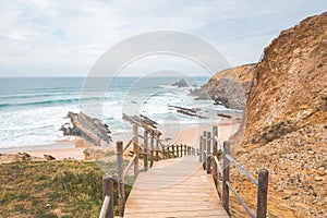 Wooden stairs as the entrance to Alteirinhos Beach near Zambujeira do Mar, Odemira region, western Portugal. Wandering along the photo