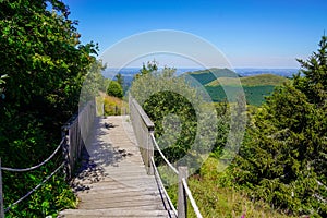 Wooden stairs in the forest and mountain volcano in center France puy de dome