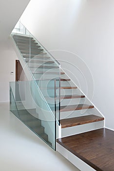 Wooden stairs with glass balustrade