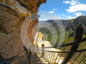 Wooden stairs at hiking trail along the cliff with beautiful mountain view of Wentworth Falls, New south wales, Australia.