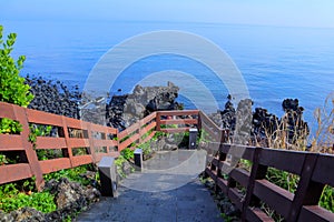 Wooden stairs leading to the volcanic beach