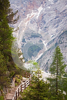 Wooden stairs in the mountains with mudflow on background