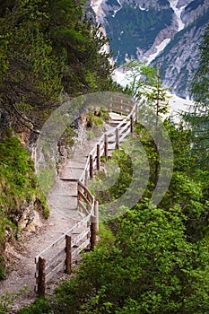 Wooden stairs in the mountains with mudflow on background