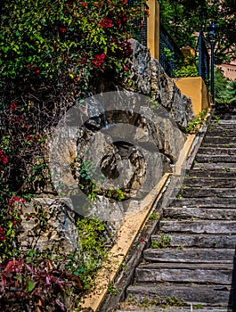 Wooden stairs in playground in marbella with stone wall