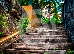 Wooden stairs in playground in marbella with stone wall