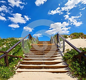 Wooden stairs with railing at beach buried