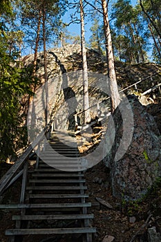 Wooden stairs to the peak of the rock in the national park Repovesi, Finland