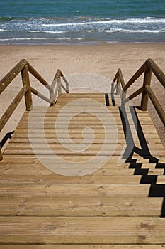Wooden stairs to the sea of the Alfonso XIII park in Guardamar del Segura, Alicante, Spain photo