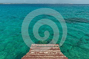 Wooden stairs to turquoise ocean