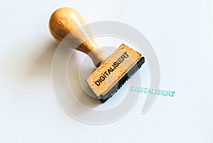 A wooden stamp marks the geman word