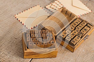 Wooden stamps alphabet and vintage envelopes