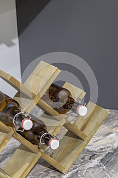 Wooden stand for bottles on the table in the kitchen.