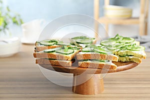 Wooden stand with traditional English cucumber sandwiches