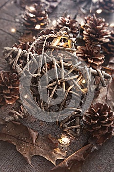 Wooden star with pine cones and leaves