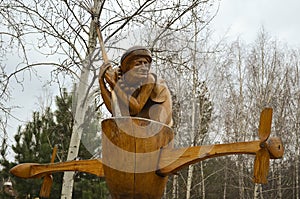 The wooden statue of Baba Yaga in a mortar  with a broom