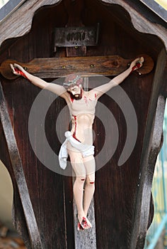 Wooden statue depicting crucified Jesus and the INRI writings on