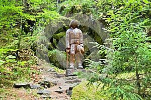 Wooden statue in a forest open-air museum in Vydrovo.