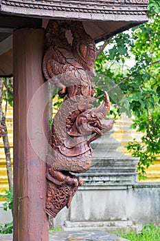 Wooden statue of King of Naga & x28;Serpent King& x29; on wooden poll