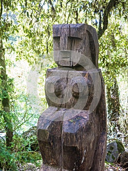 Wooden statue, in the middle of the Huilo Huilo Biological Reserve, regressing animals and Mapuche mystical characters from