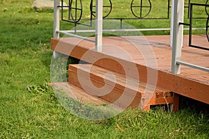 Wooden step on green background. Backyard Deck